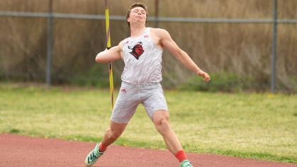 Male college athlete prepares to throw a javelin.