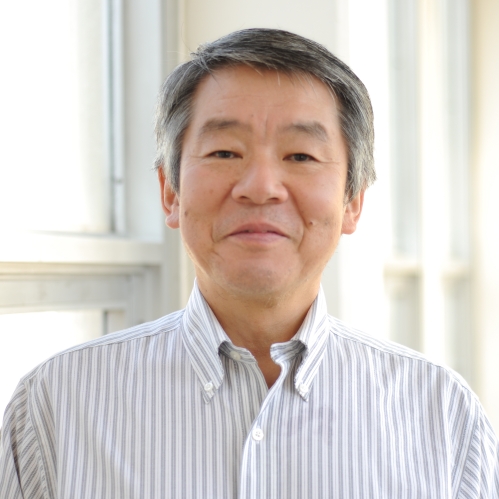 Head shot of Asian male wearing a white patterned button down shirt.