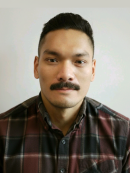 man with red and brown plaid shirt in front of white background