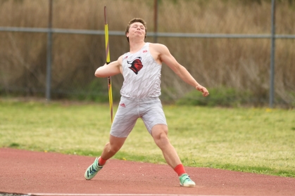 Male college athlete prepares to throw a javelin.