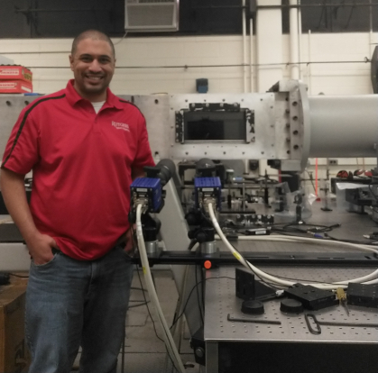 Man standing next to technical equipment.