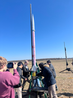 The AIAA Rutgers Rocket Propulsion Lab working on a small rocket outside